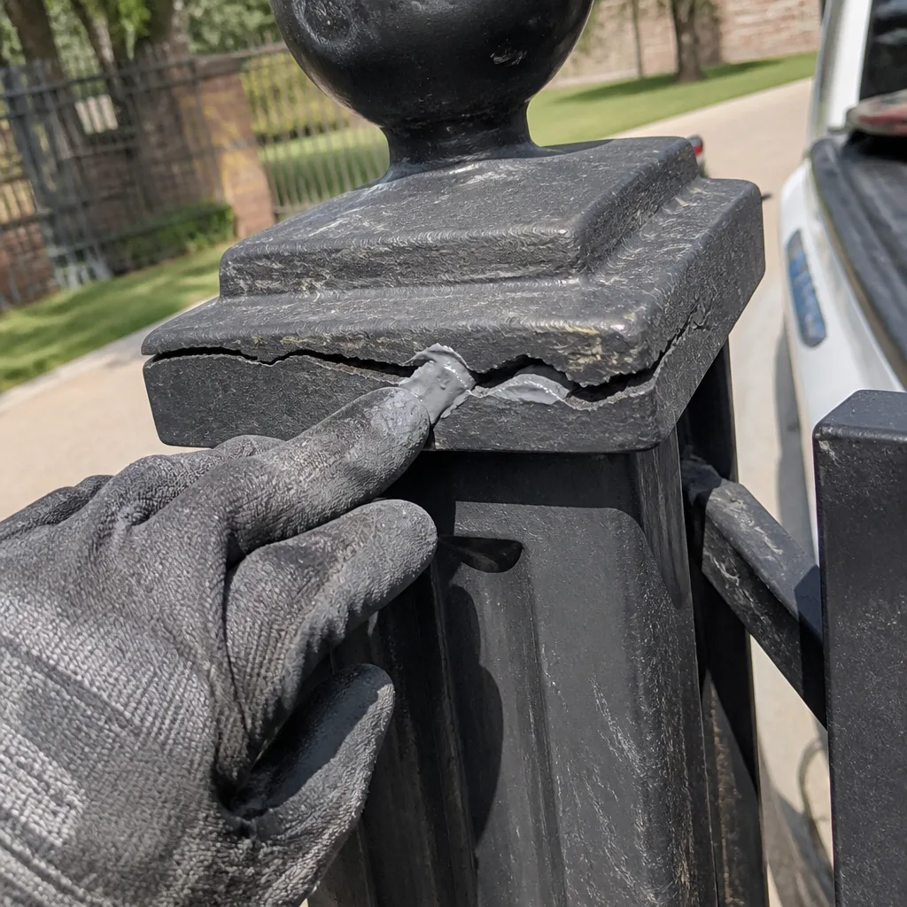 Professional gate post repair with metal sealant applied to decorative cap